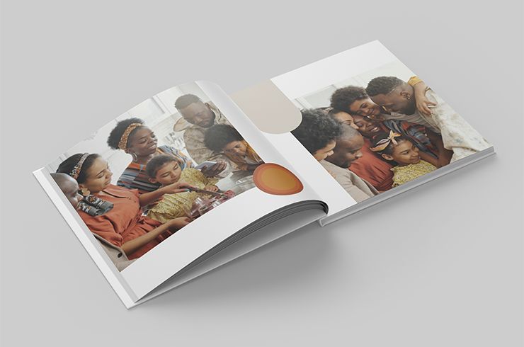 Open book showing a family photo on a gray background